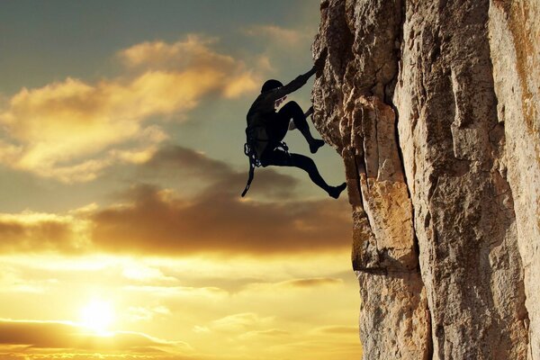 Sunset rock climber sheer cliff effort