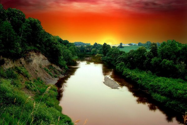 Sunrise by the water in nature in the early morning