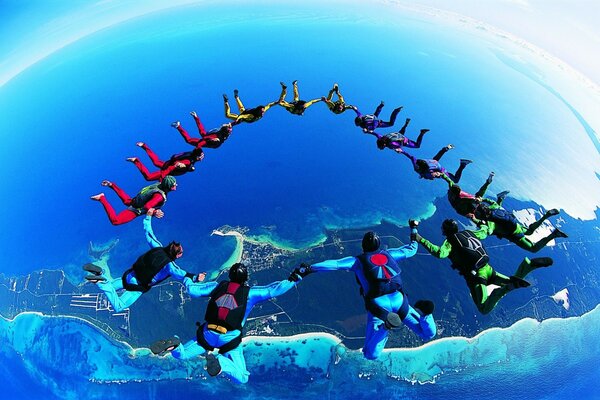 A circle of parachutists on the background of the earth