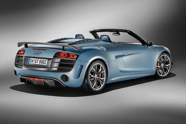 Blue Audi with an open top on a gray background