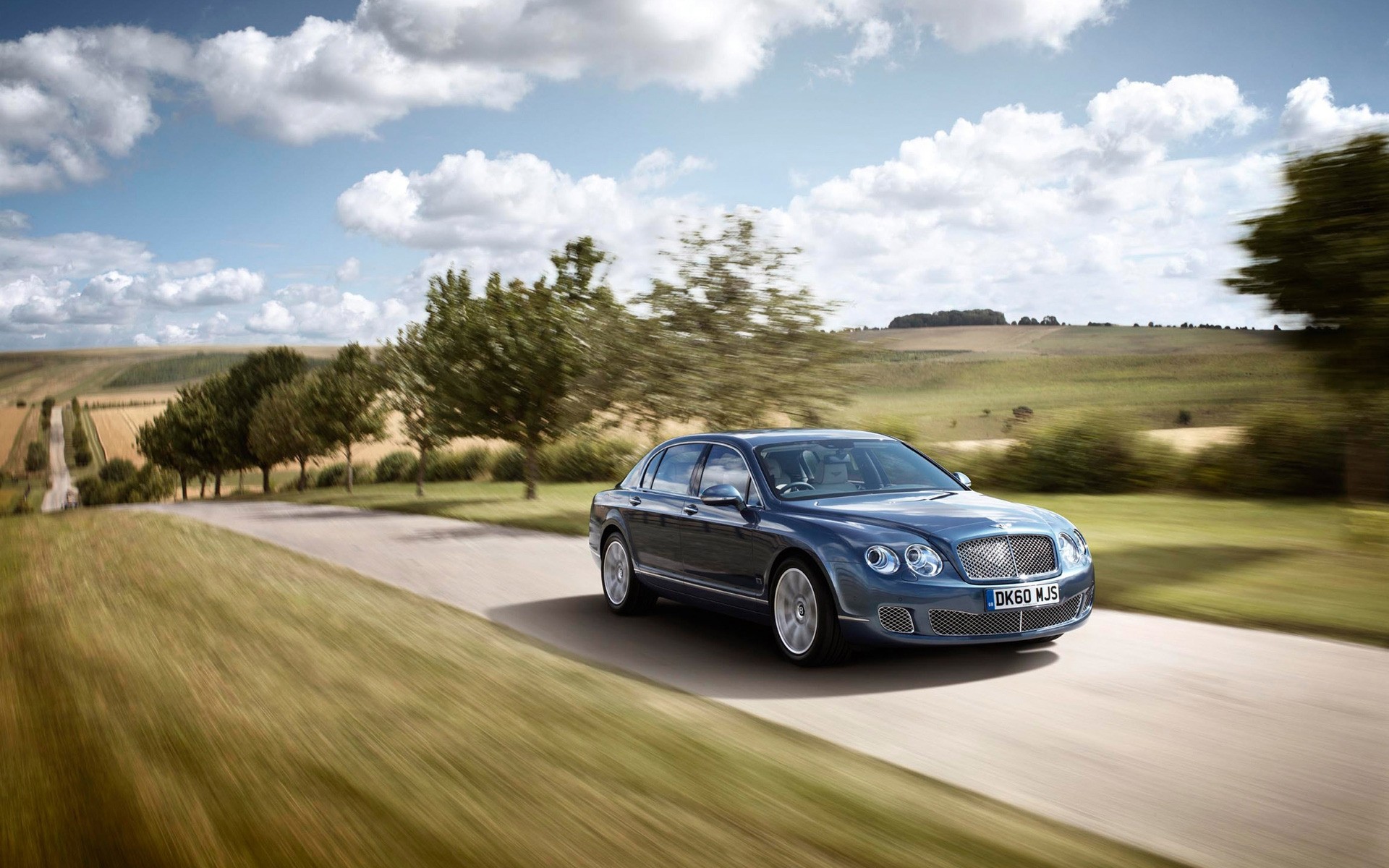 bentley car road vehicle drive asphalt landscape blacktop pavement transportation system action grass hurry golf travel blur bentley flying spur