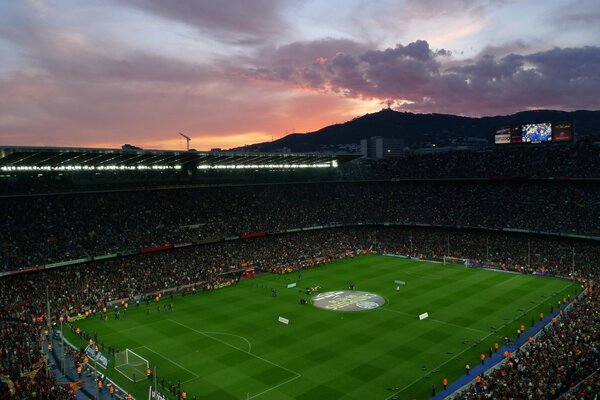 Stadium against the backdrop of mountains and the setting sun