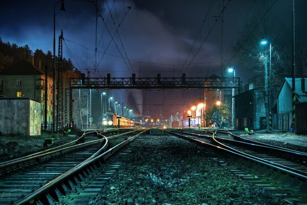 Night railway tracks in the light of lights