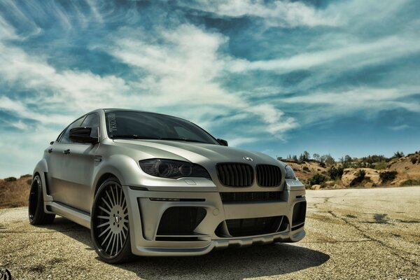 Grey BMW in a desert area