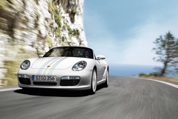 White Porsche convertible on the highway