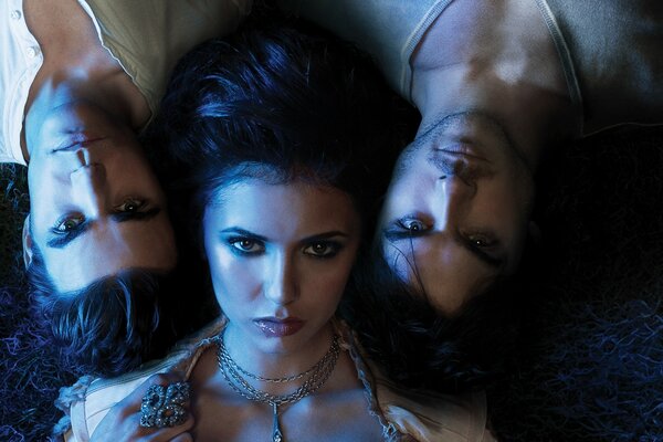 Three girls lying on the floor from the TV series