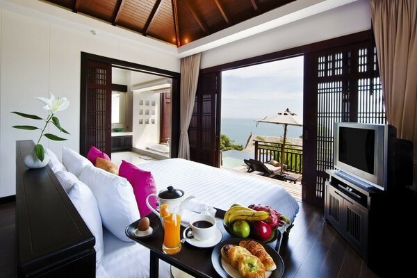 Bed in front of the balcony with sea view