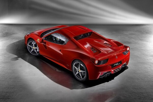 A red Ferrari car standing on the asphalt