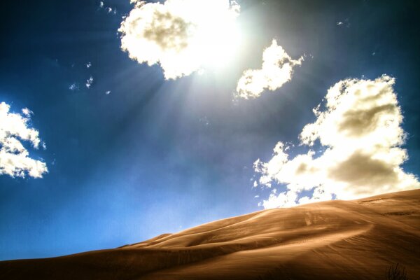 Desert dunes against the blue sky