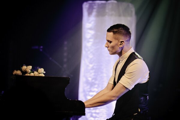 A man expressively sitting at a musical instrument