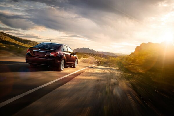 Subaru au coucher du soleil se précipite sur la piste