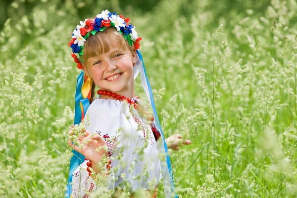 Beautiful girl in a wreath in nature