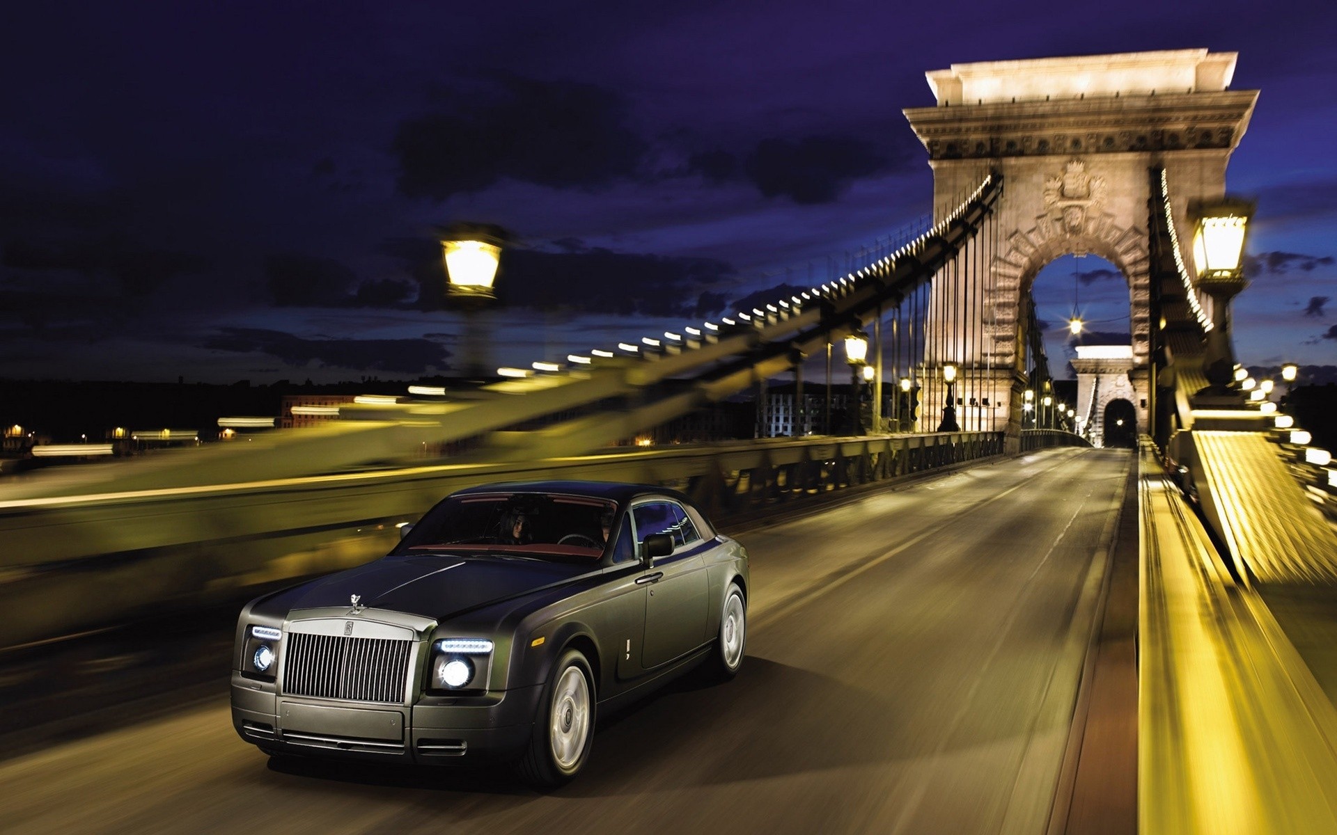 rolls royce car road transportation system street travel traffic blur vehicle city architecture light fast pavement dusk bridge sunset