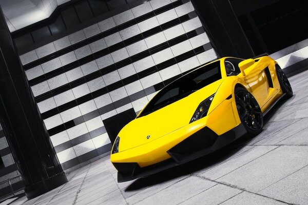 A yellow lamborghini is standing on the road