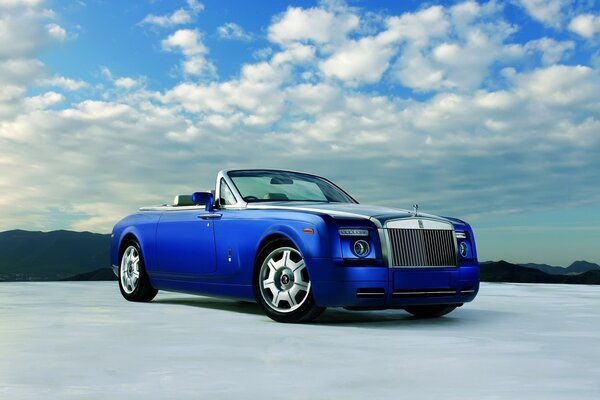 A blue car with an open top, and clouds above it