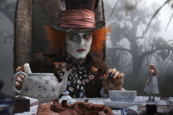 The hatter and Alice at a tea party for the desktop