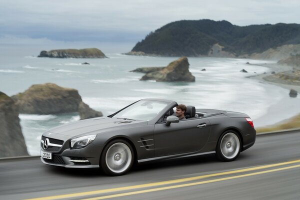 A car driving along the shore