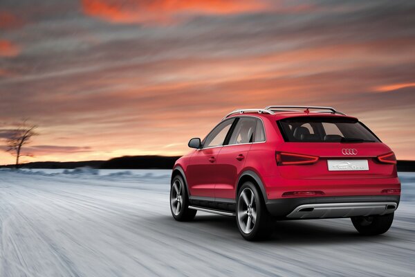 Auto rossa del marchio Audi sulla strada innevata