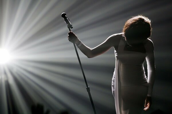 A girl with a microphone on stage