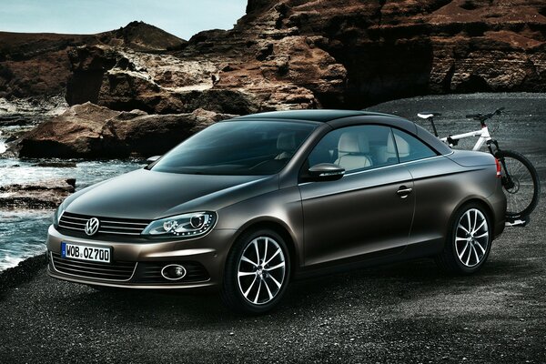 Volkswagen car on the asphalt with a bicycle