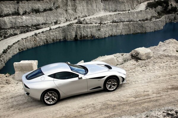 High-speed car on the shore of a mountain lake