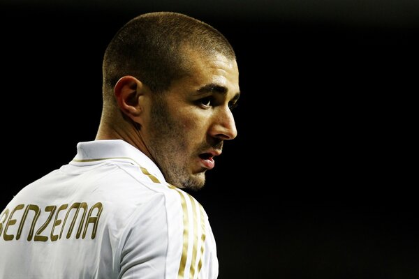 Thoughtful Benzema in white and gold uniform