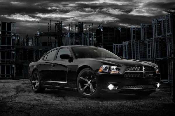 Black car on the background of an abandoned building