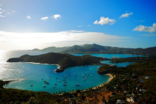 A bay with ships. Transparent, blue sea and a bay with ships