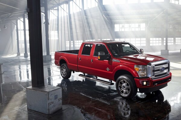 Ford car in the back of a pickup truck in red