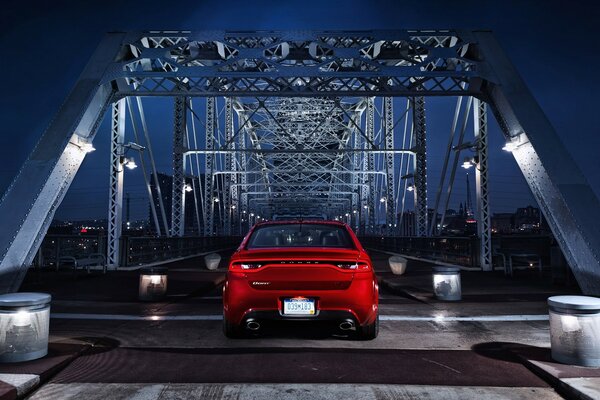 سيارة حمراء على الجسر الليلي