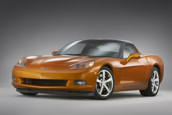 A bronze-colored sports car on a gray background