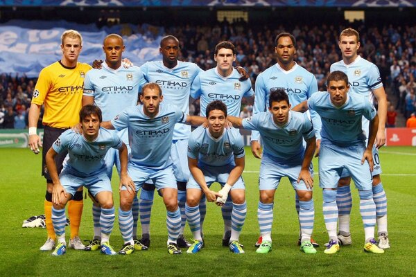 Football team on the background of the stadium with fans