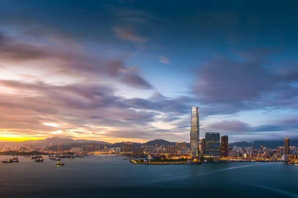 The sky and the water are separated by the lights of the city