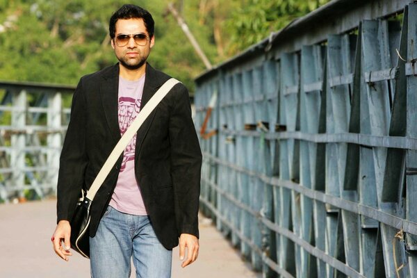 A man in sunglasses on the background of the bridge