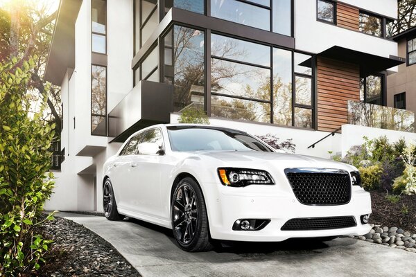 Beautiful white car on the background of a house