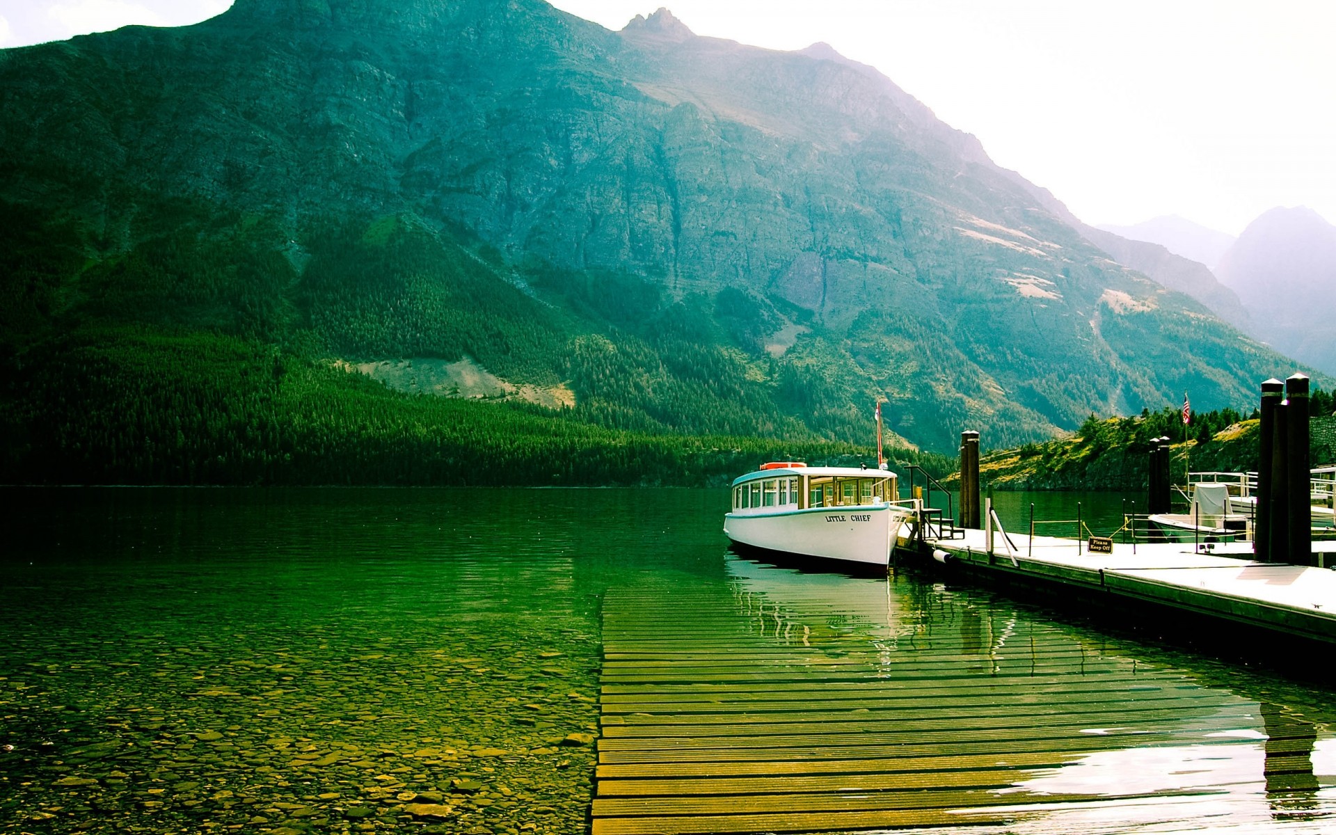 united states water travel nature mountain lake landscape wood summer sky outdoors boat tree mountain lake dock cutter glacier national park