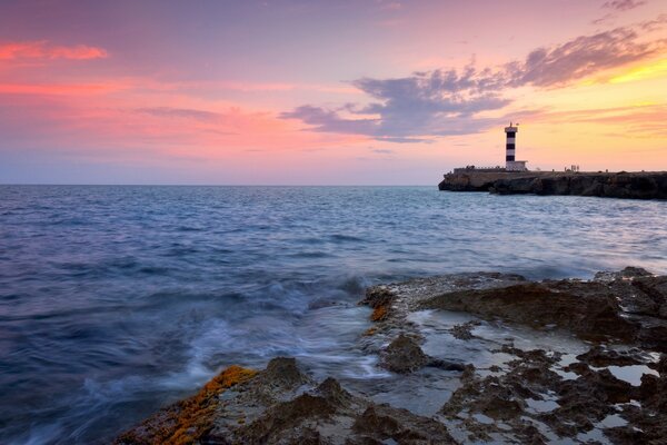 A lonely lighthouse in the twilight of sunset