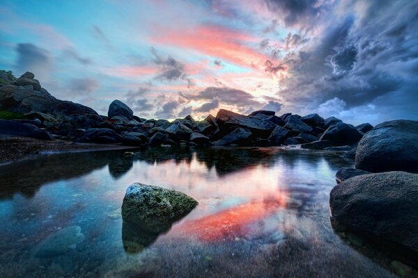 Fiery sunset on a rocky shore