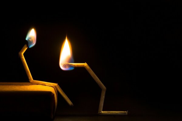 Two matches are burning flame fire light