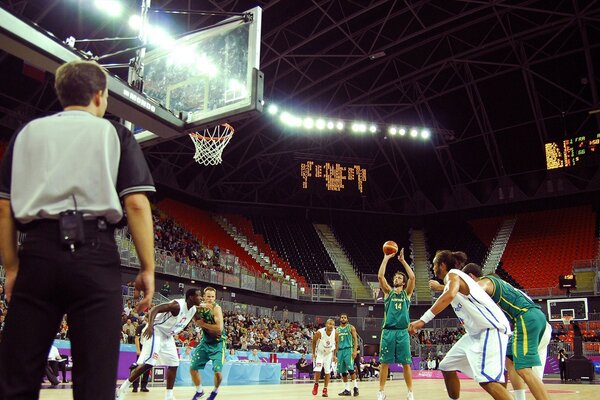 A basketball player tries to score a three-point shot