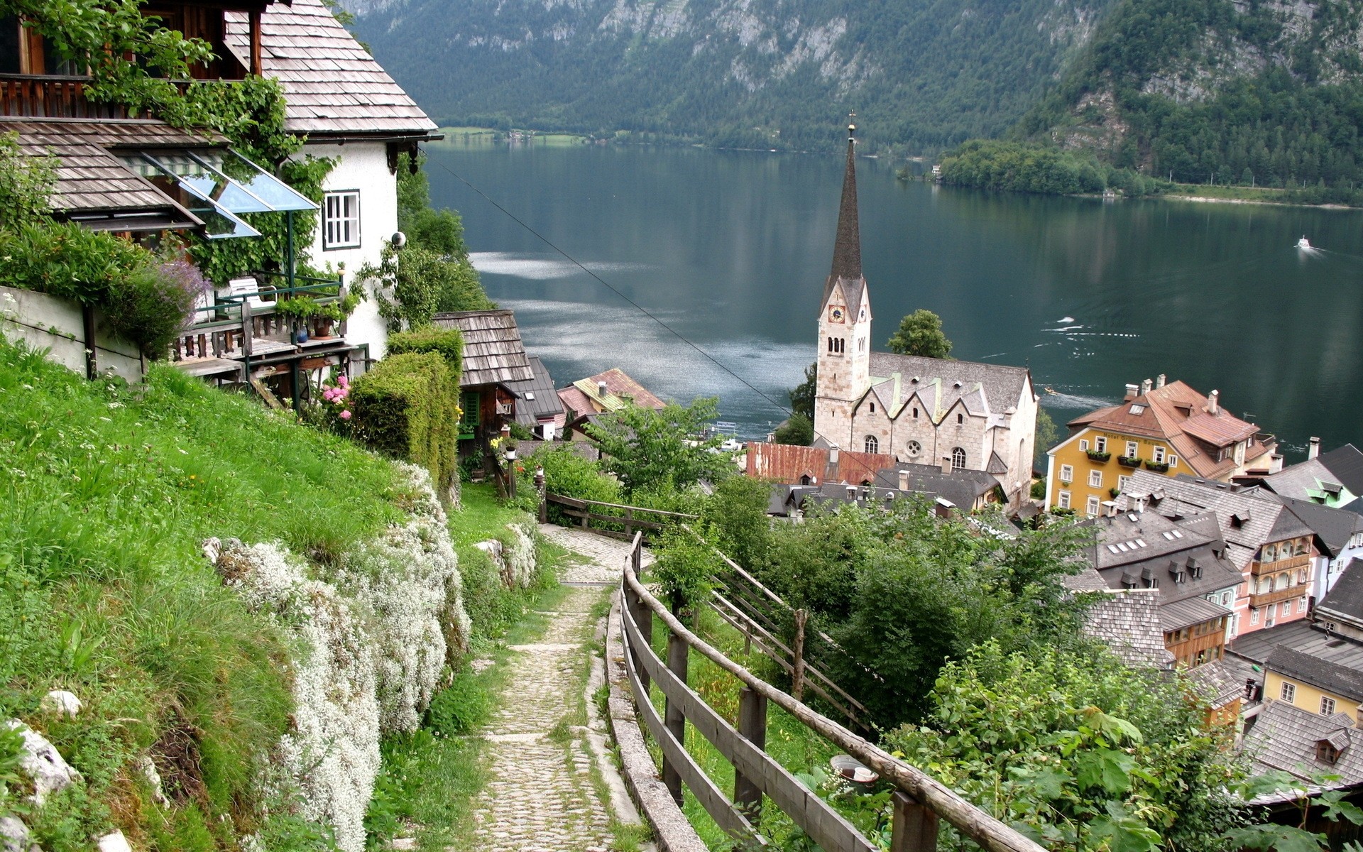other city architecture travel house building water town church tourism outdoors old summer landscape river sight roof city sky hill tree village salzkammergut background