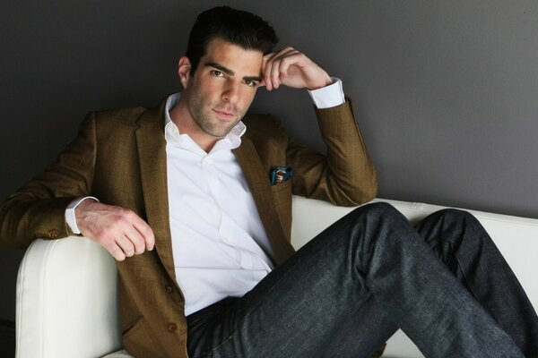 Zachary Quinto poses on the couch