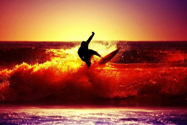 Extreme surfing in a crimson sunset