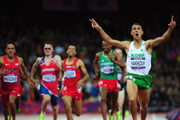 Athletes run up to the finish line of the race