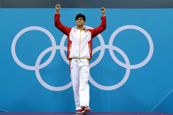 Olympic champion on the background of Olympic rings