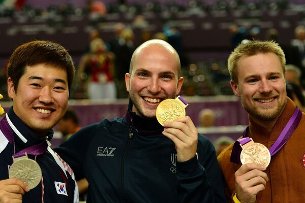 Olympic Games medal award three people