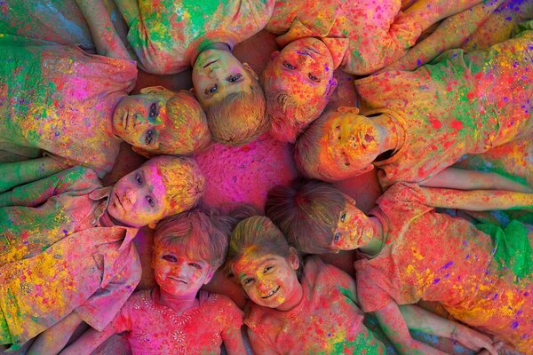 Bright and smiling children lie in a circle