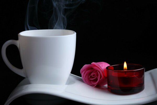 A cup of hot drink, a candle