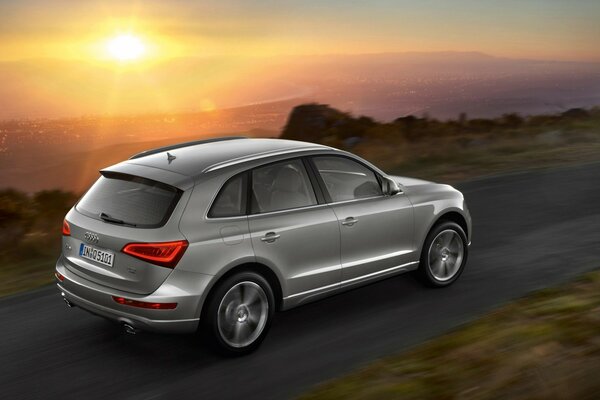 Audi passenger car on the road with sunset