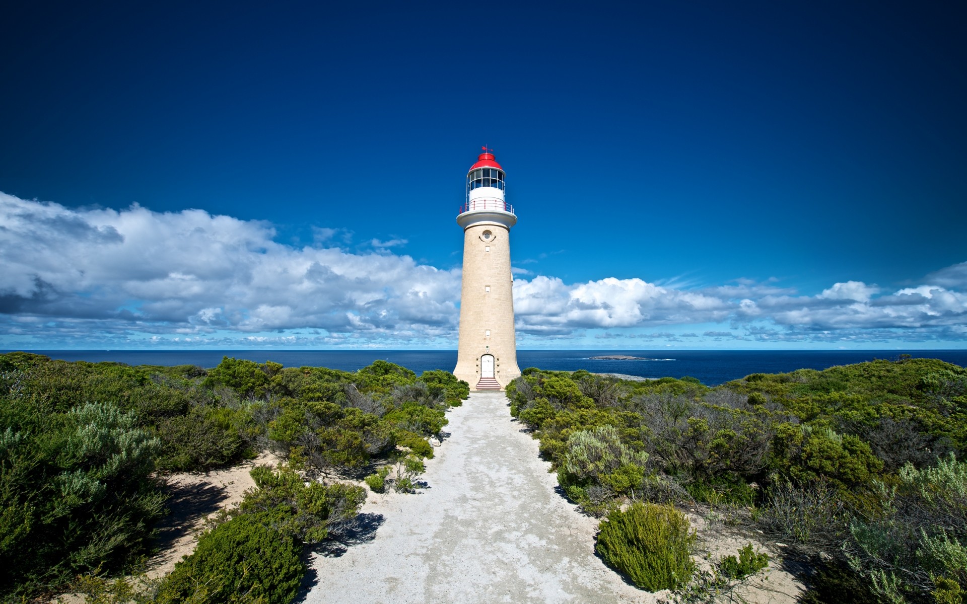 australia lighthouse sea seashore sky ocean water beach travel landscape outdoors nature seascape island rock tower blue sky light house background